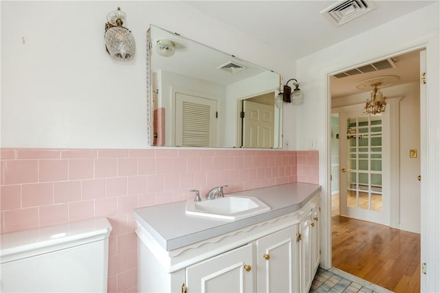 11 Macintosh Dr, Smithfield, RI 02828 - bathroom with vanity, a chandelier, and decorative backsplash