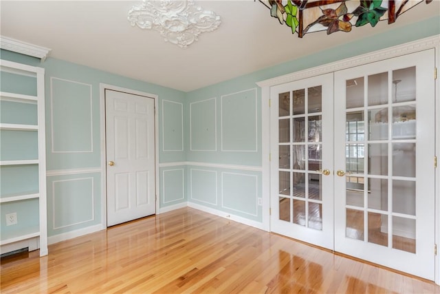 11 Macintosh Dr, Smithfield, RI 02828 - unfurnished dining area featuring a decorative wall, french doors, a chandelier, and wood finished floors