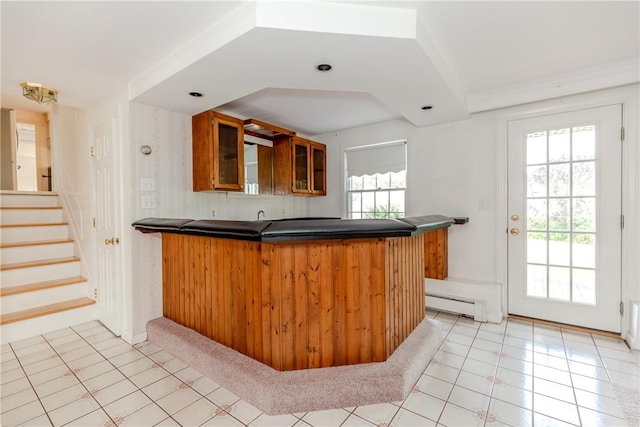 11 Macintosh Dr, Smithfield, RI 02828 - kitchen with a peninsula, dark countertops, brown cabinetry, glass insert cabinets, and baseboard heating