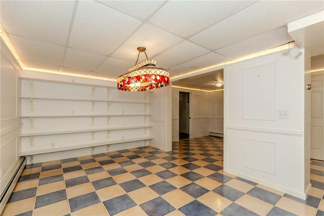 11 Macintosh Dr, Smithfield, RI 02828 - basement featuring a baseboard radiator, a paneled ceiling, a decorative wall, and light floors