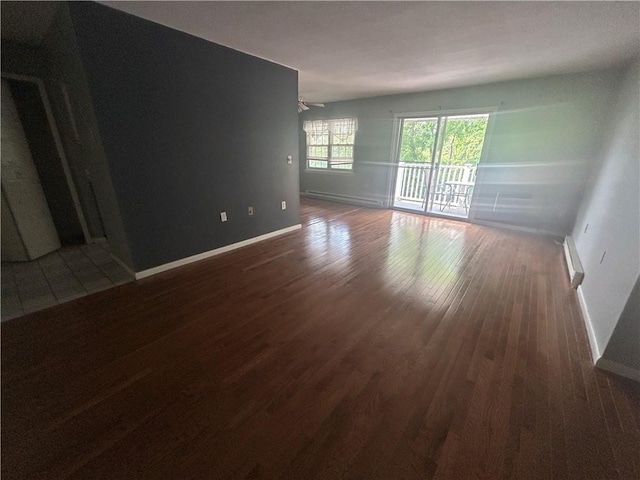 25 Bullocks Point Ave Unit 5C, East Providence, RI 02915 - unfurnished room with wood finished floors, a baseboard heating unit, a ceiling fan, and a baseboard radiator