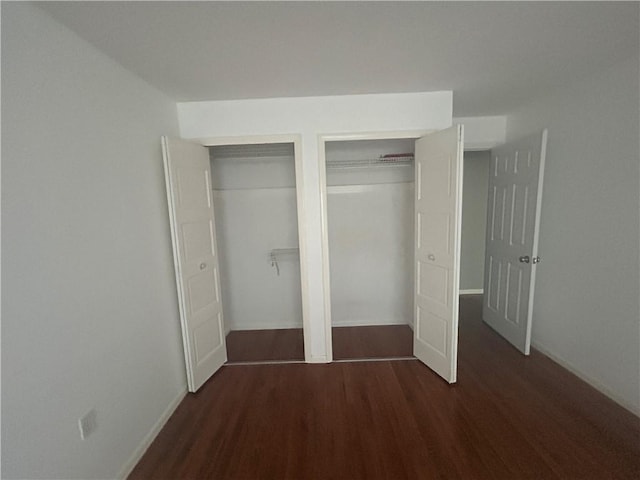 25 Bullocks Point Ave Unit 5C, East Providence, RI 02915 - unfurnished bedroom with multiple closets and dark wood finished floors