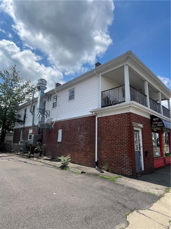 877 Central Ave, Pawtucket, RI 02861 - view of property exterior featuring a balcony and brick siding
