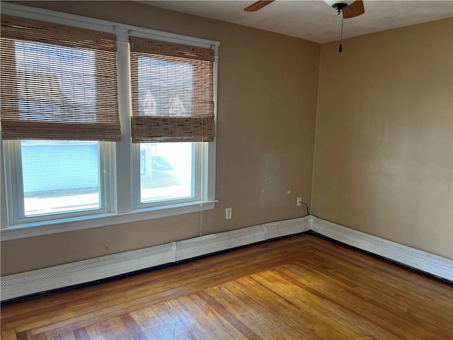 877 Central Ave, Pawtucket, RI 02861 - unfurnished room with a ceiling fan, a baseboard radiator, and wood finished floors