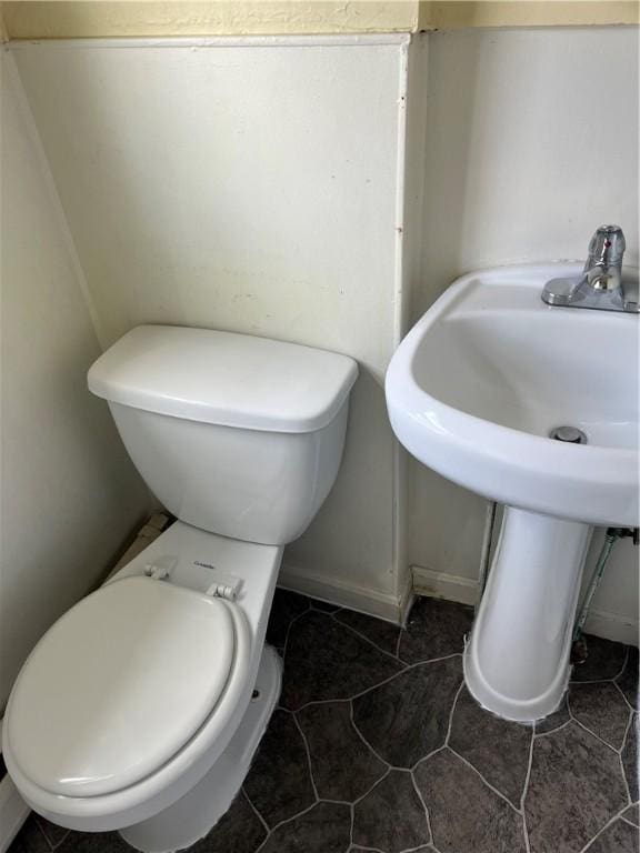 877 Central Ave, Pawtucket, RI 02861 - half bathroom featuring toilet and tile patterned floors