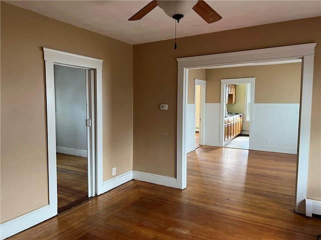 877 Central Ave, Pawtucket, RI 02861 - empty room with hardwood / wood-style flooring, ceiling fan, and wainscoting