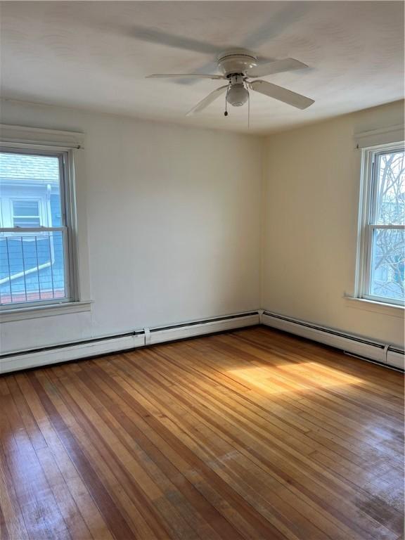 877 Central Ave, Pawtucket, RI 02861 - spare room with hardwood / wood-style floors, ceiling fan, and baseboard heating