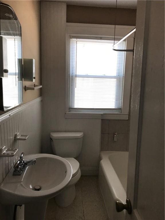 877 Central Ave, Pawtucket, RI 02861 - full bathroom featuring a bathtub, a shower, tile patterned floors, and wainscoting