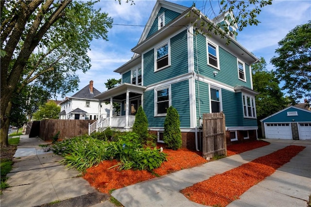 192 Lenox Ave, Providence, RI 02907 - view of front of house with an outbuilding, a detached garage, and covered porch