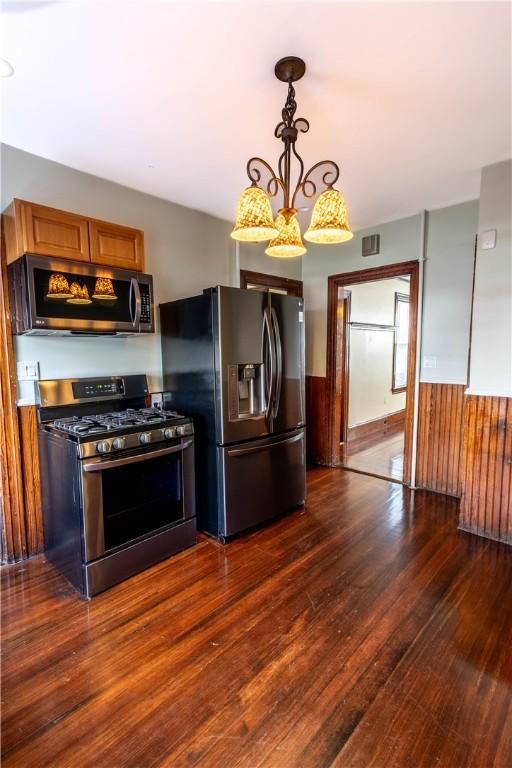 192 Lenox Ave, Providence, RI 02907 - kitchen featuring stainless steel appliances, dark wood-style floors, brown cabinets, and pendant lighting