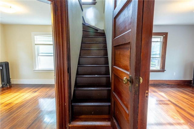 192 Lenox Ave, Providence, RI 02907 - stairway featuring radiator, plenty of natural light, and wood-type flooring