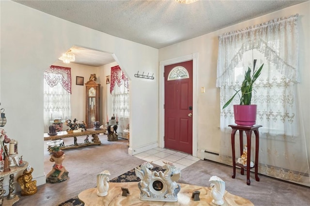 22 Parsons Ave, East Providence, RI 02914 - tiled entrance foyer with carpet flooring, a textured ceiling, a chandelier, and arched walkways