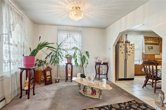 22 Parsons Ave, East Providence, RI 02914 - foyer entrance featuring a textured ceiling, a baseboard radiator, a chandelier, and arched walkways