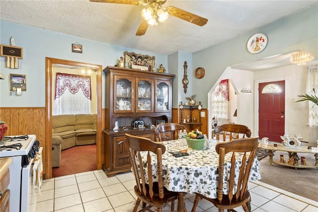 22 Parsons Ave, East Providence, RI 02914 - dining space featuring light tile patterned floors, light colored carpet, wainscoting, a textured ceiling, and ceiling fan