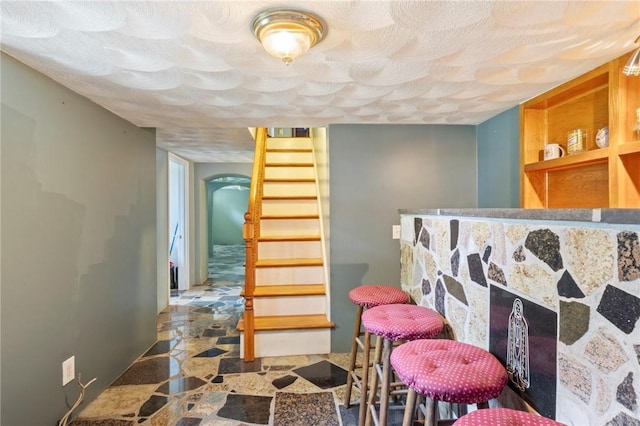 22 Parsons Ave, East Providence, RI 02914 - interior space with stairway, a bar, stone finish floors, and arched walkways