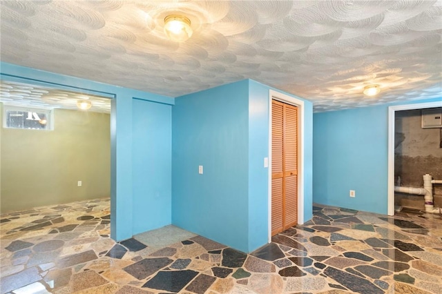22 Parsons Ave, East Providence, RI 02914 - basement featuring stone flooring and a textured ceiling