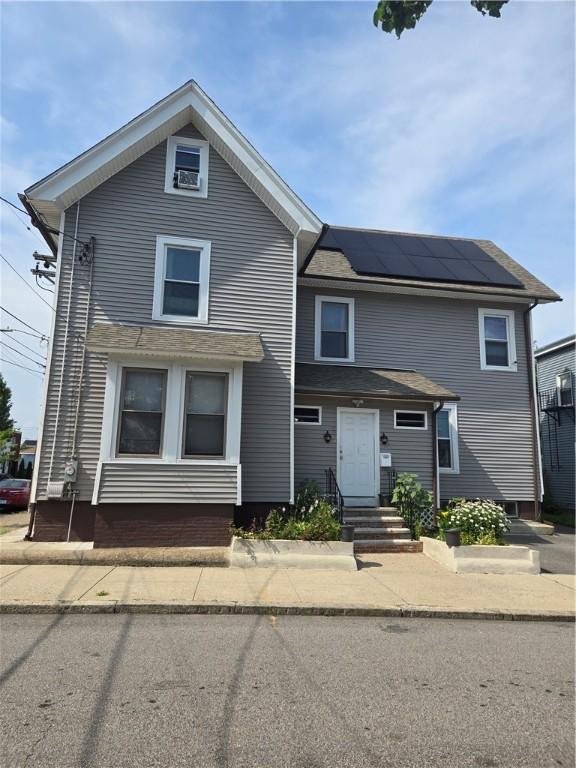 45 Harrison St, Pawtucket, RI 02860 - view of front facade featuring roof mounted solar panels