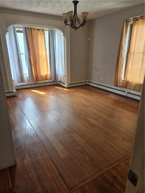 45 Harrison St, Pawtucket, RI 02860 - unfurnished room featuring dark wood-type flooring and a chandelier