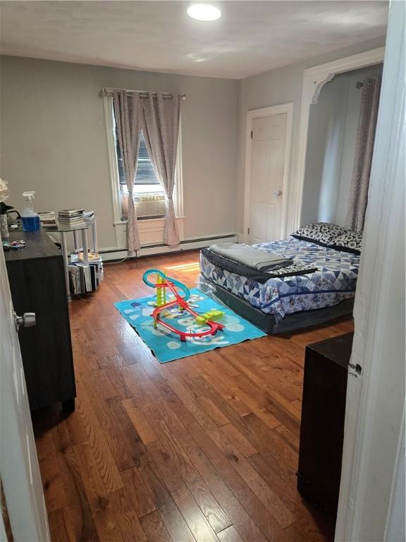 45 Harrison St, Pawtucket, RI 02860 - bedroom with wood finished floors and a baseboard heating unit