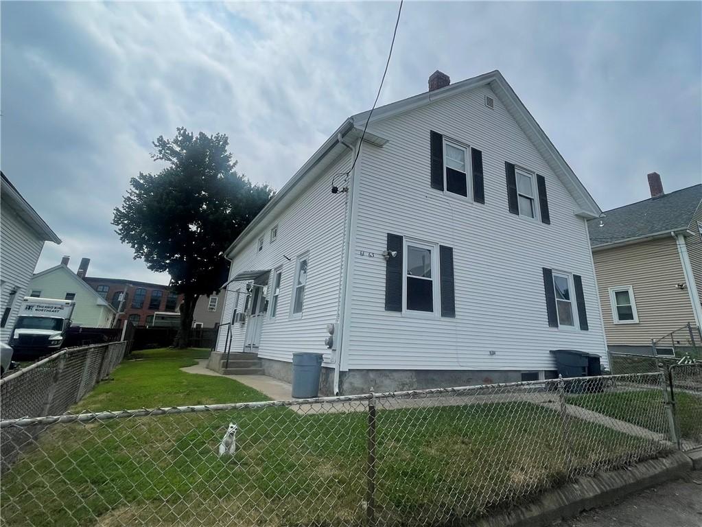 61 Maple Ave, Johnston, RI 02919 - view of property exterior featuring entry steps, a fenced backyard, and a chimney