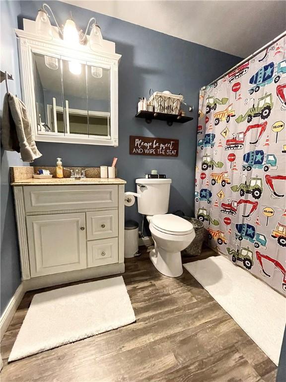 8 Orchard St, West Warwick, RI 02893 - bathroom with wood finished floors, vanity, and a shower with curtain
