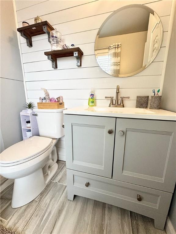 8 Orchard St, West Warwick, RI 02893 - bathroom featuring wood finished floors and vanity