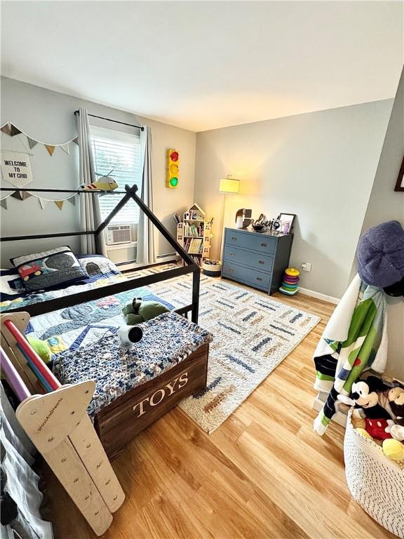 8 Orchard St, West Warwick, RI 02893 - bedroom featuring wood finished floors and cooling unit