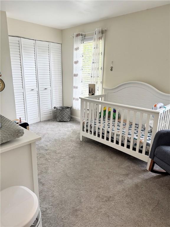 8 Orchard St, West Warwick, RI 02893 - carpeted bedroom featuring a closet and a nursery area