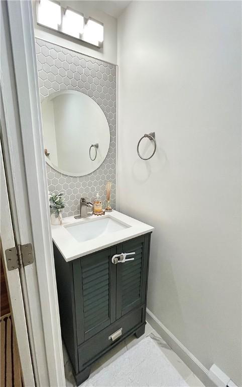 8 Orchard St, West Warwick, RI 02893 - bathroom with vanity and tasteful backsplash