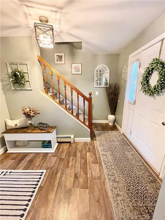 8 Orchard St, West Warwick, RI 02893 - entryway featuring wood finished floors and stairway