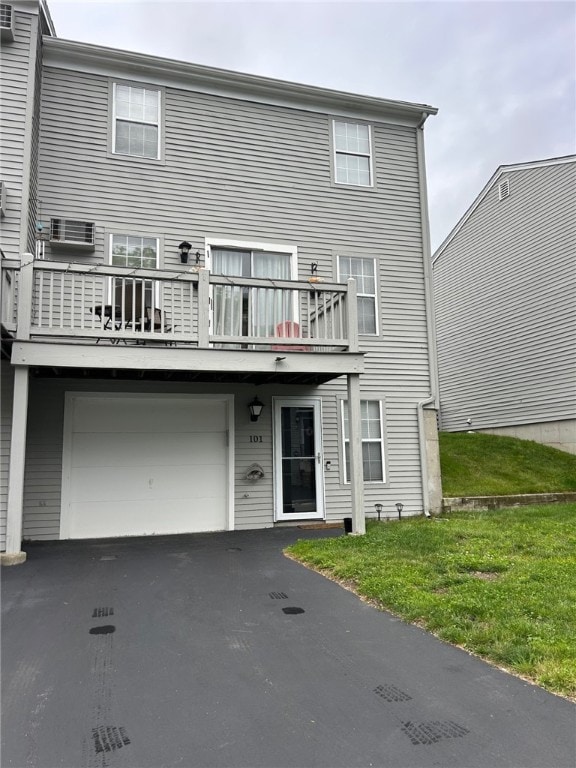 565 Quaker Ln Unit 101, West Warwick, RI 02893 - view of front of house with a balcony, an attached garage, and asphalt driveway