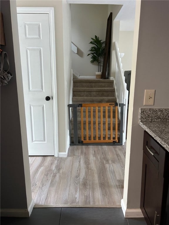 565 Quaker Ln Unit 101, West Warwick, RI 02893 - stairs featuring wood finished floors and baseboards