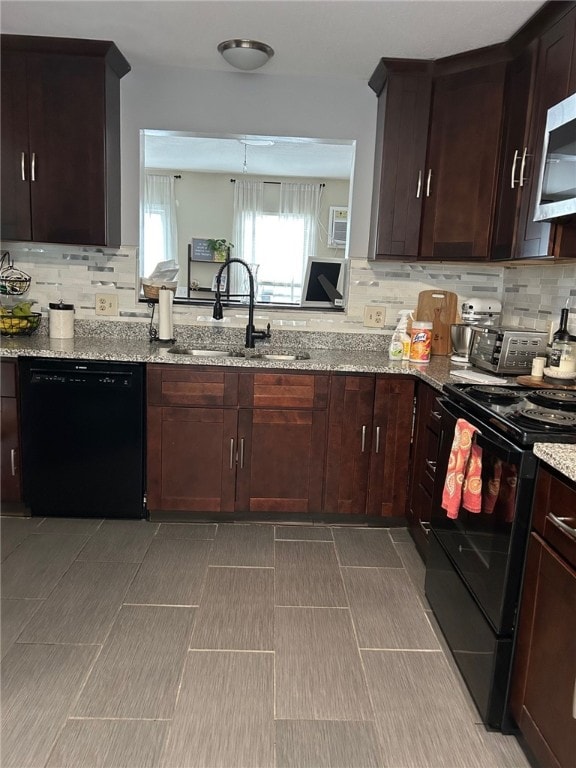 565 Quaker Ln Unit 101, West Warwick, RI 02893 - kitchen featuring black appliances, backsplash, light stone countertops, and dark brown cabinets