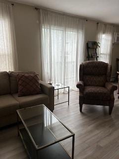 565 Quaker Ln Unit 101, West Warwick, RI 02893 - living area with healthy amount of natural light and wood finished floors