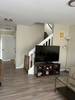 565 Quaker Ln Unit 101, West Warwick, RI 02893 - living area featuring wood finished floors and stairway