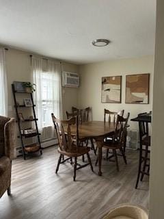 565 Quaker Ln Unit 101, West Warwick, RI 02893 - dining area featuring light wood-style flooring and an AC wall unit