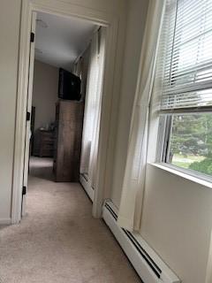 565 Quaker Ln Unit 101, West Warwick, RI 02893 - corridor with a baseboard radiator and light carpet