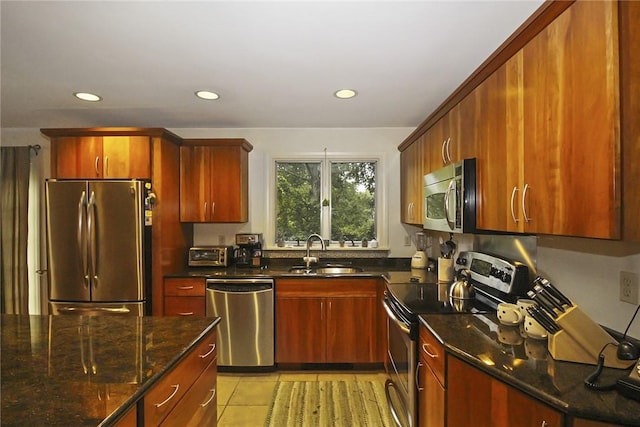 60 Tower Hill Rd, Tiverton, RI 02878 - kitchen featuring stainless steel appliances, recessed lighting, dark stone counters, light tile patterned floors, and reddish brown cabinets
