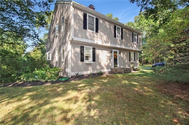 60 Tower Hill Rd, Tiverton, RI 02878 - colonial-style house featuring a front yard and a chimney