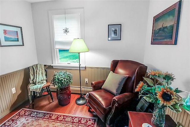 60 Tower Hill Rd, Tiverton, RI 02878 - living area featuring a wainscoted wall, wood finished floors, baseboard heating, and wood walls
