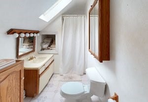 60 Tower Hill Rd, Tiverton, RI 02878 - bathroom featuring a skylight, vanity, lofted ceiling, and a shower with shower curtain