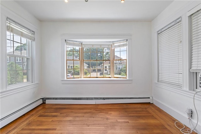 68 Friendly Rd, Cranston, RI 02910 - spare room featuring a baseboard heating unit and wood finished floors