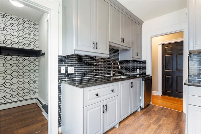 68 Friendly Rd, Cranston, RI 02910 - kitchen with dishwasher, light wood-type flooring, decorative backsplash, dark stone counters, and white cabinets