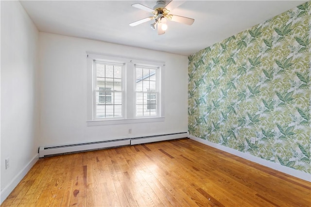 68 Friendly Rd, Cranston, RI 02910 - spare room featuring wallpapered walls, baseboard heating, light wood finished floors, a ceiling fan, and an accent wall