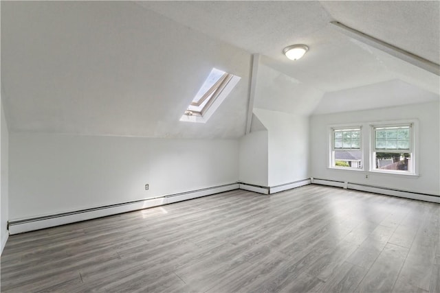 68 Friendly Rd, Cranston, RI 02910 - additional living space featuring lofted ceiling, wood finished floors, a skylight, and a baseboard radiator