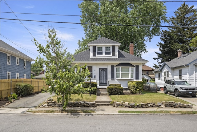 68 Friendly Rd, Cranston, RI 02910 - view of front of house featuring roof with shingles, a chimney, and driveway