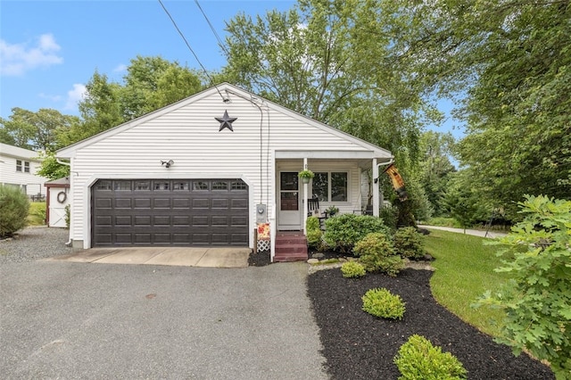 27 Nixon St, Cumberland, RI 02864 - ranch-style home featuring covered porch, an attached garage, and driveway