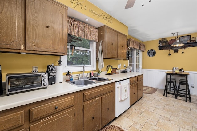 27 Nixon St, Cumberland, RI 02864 - kitchen featuring dishwasher, wainscoting, light countertops, a ceiling fan, and light stone finish floors