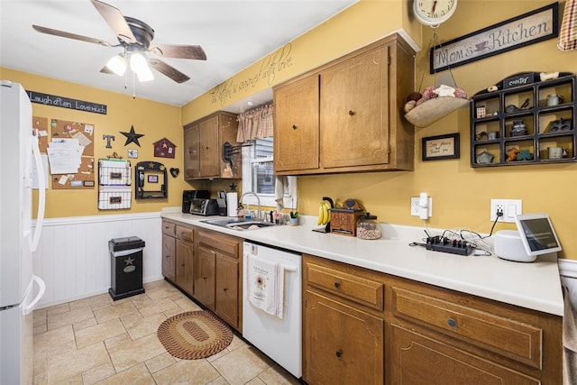 27 Nixon St, Cumberland, RI 02864 - kitchen featuring white appliances, ceiling fan, light countertops, wainscoting, and brown cabinetry
