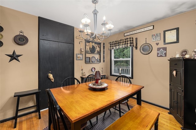 27 Nixon St, Cumberland, RI 02864 - dining space with a chandelier and light wood-style flooring